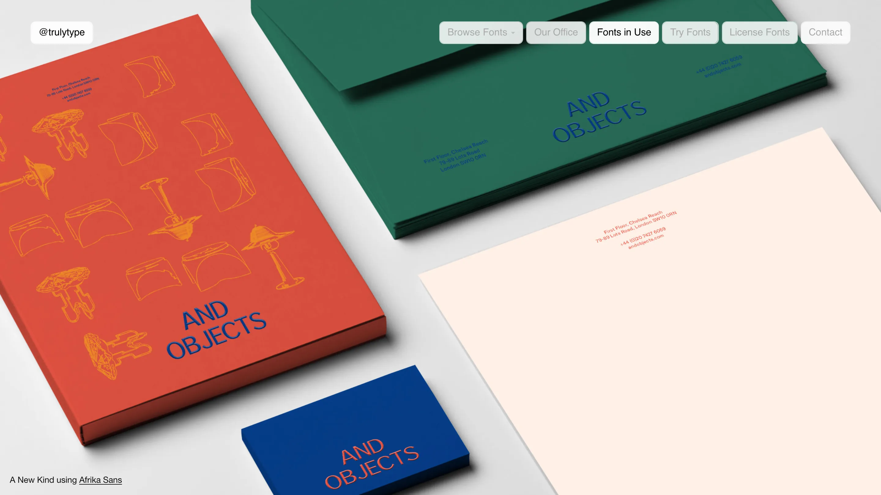 Fonts in Use page: And Objects stationery, a red catalogue, green envelope, cream letterhead and blue business card set in Afrika Sans.