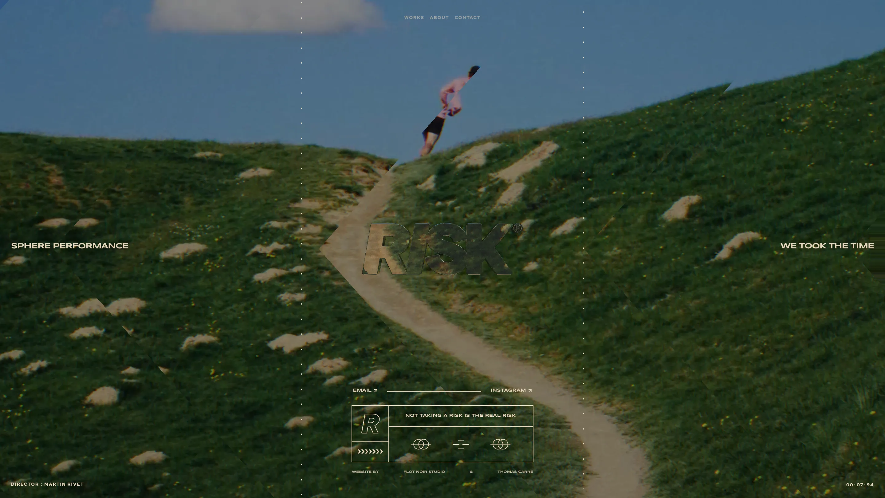 RISK homepage: a full-bleed still of a runner cresting a grassy hill under blue sky, with the RISK wordmark rendered as a glass knockout in the centre of the frame