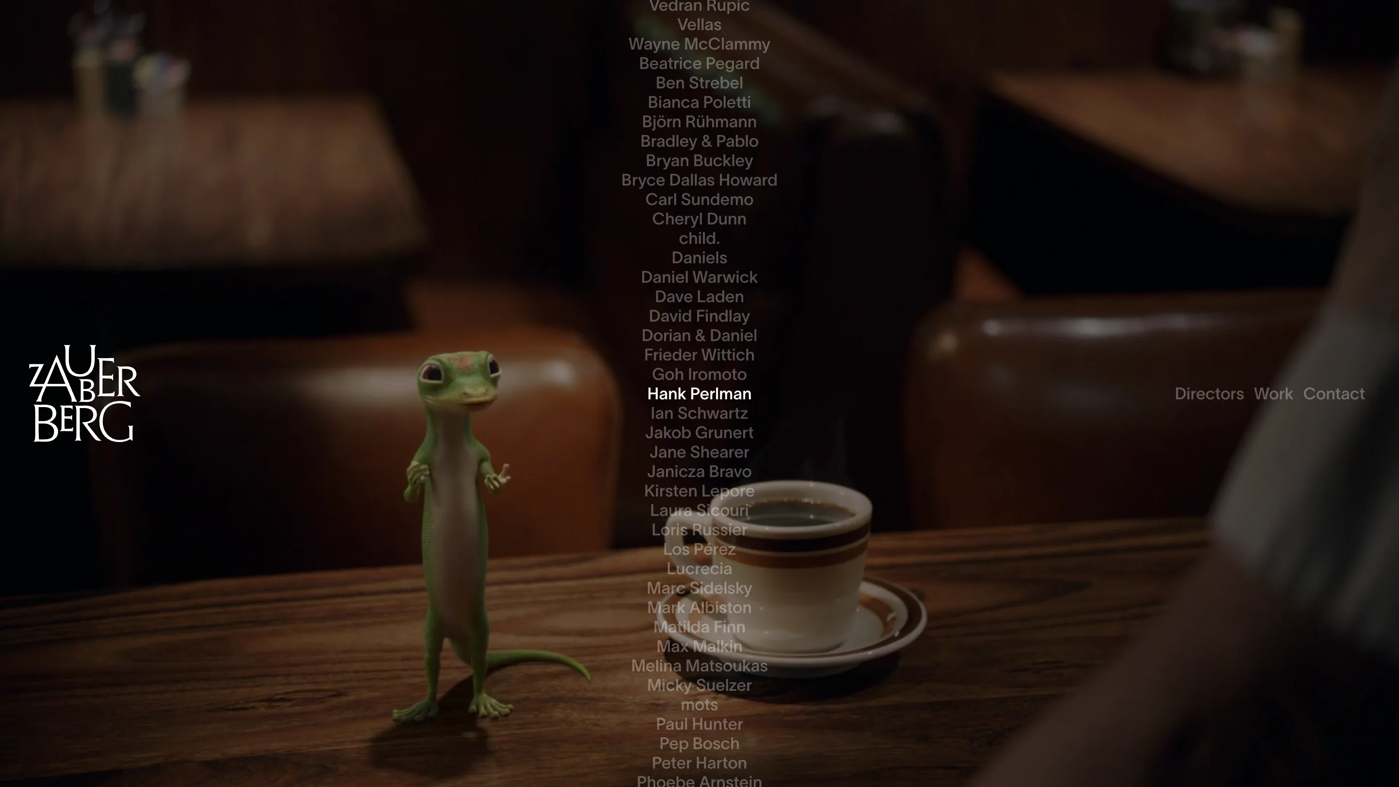 Zauberberg home page: an alphabetical column of director names in grey, with Hank Perlman highlighted in white, over a full-bleed film still of an animated gecko on a bar table