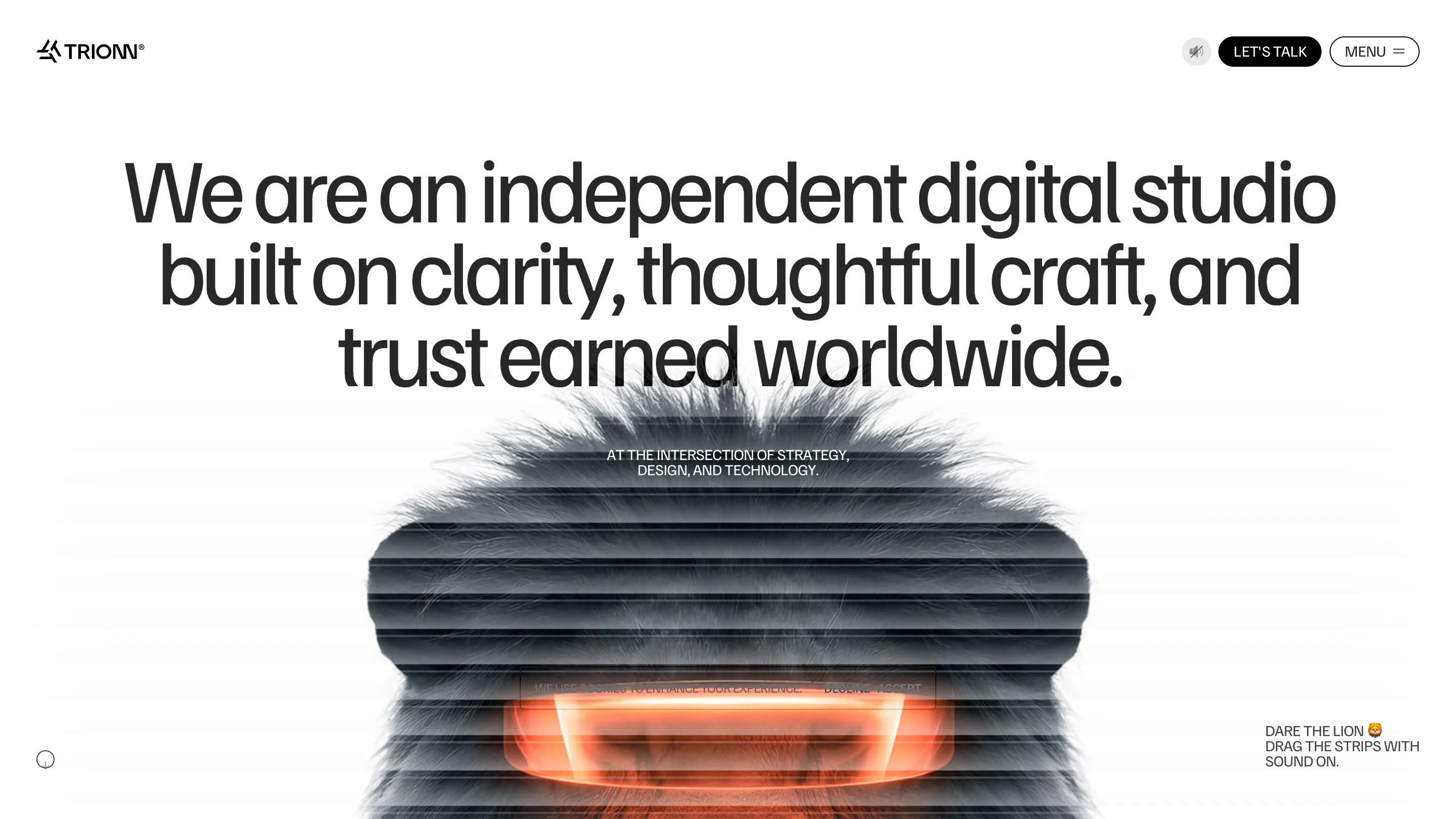 TRIONN about page in light mode: a black headline reading 'We are an independent digital studio built on clarity, thoughtful craft, and trust earned worldwide' above a lion's face made of horizontal strips with a glowing orange core.